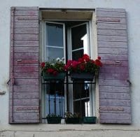 Windowboxes of red pelargoniums for a Mediterranean style garden